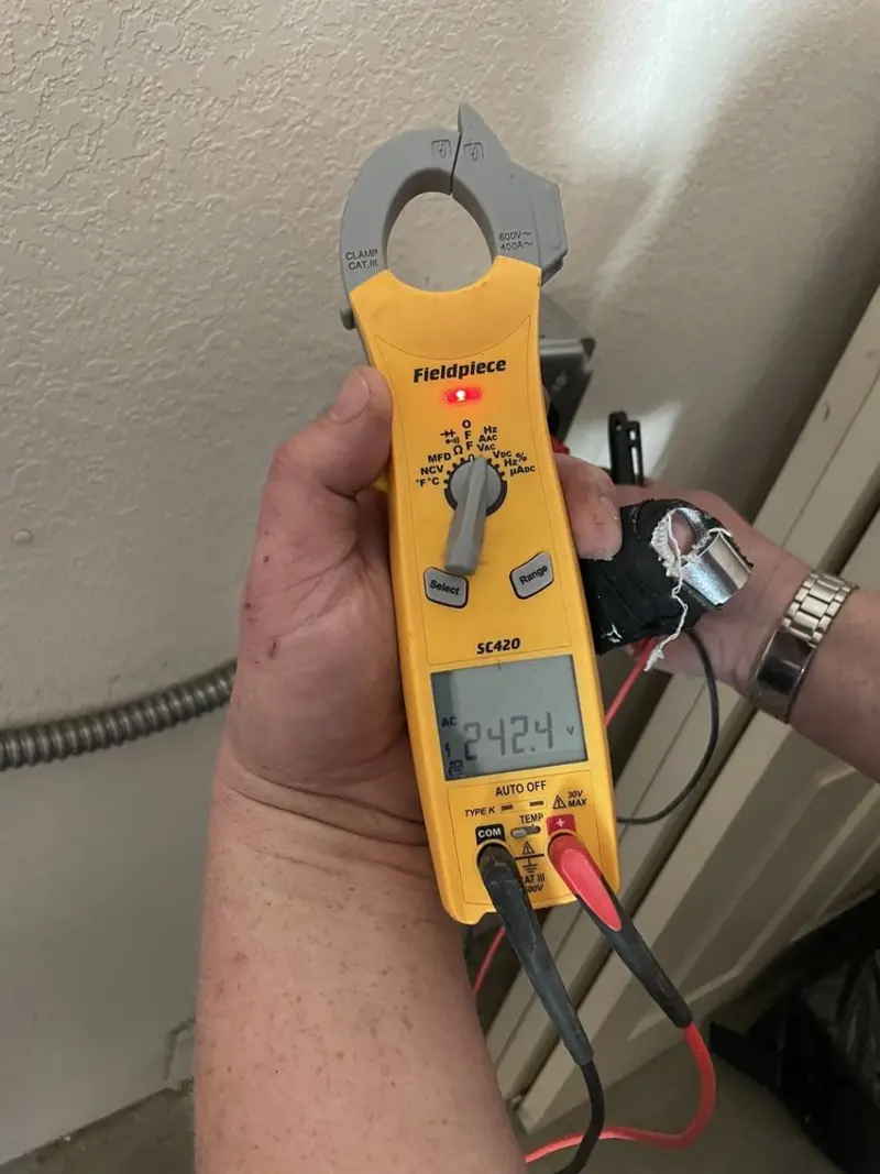 Voltage testing with clamp meter during Outlet Installation in Shaw Heights